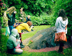 Students from the Syracuse University London Centre and Jeff Licata, one of their teachers, pause for reflection at the stone marker that signifies the crater center formed by the flaming fuel tank of Pan Am Flight 103.