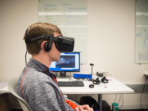 Nick Hodge, the president of 5th Medium, tries on a VR headset.