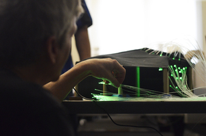 Mark Povinelli examines the students' prototype for their interactive sustainability exhibit that will occupy Bird Library later this spring.