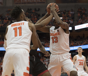 Oshae Brisset and Paschal Chukwu surround an Arkansas State player.