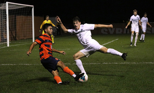 Syracuse midfielder Ryan Raposo challenges for the ball with Binghamton's Carter Beaulieu. 