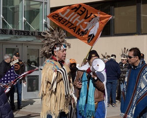 Kanietakeron speaks at Monday’s peaceful gathering to show support for the inclusion of Mohawk voices in land claim settlements, which took place outside of the James. M Hanley Federal Building and Courthouse. “We got to work our way up the ladder to people like the judge here and explain in a good way,” Kanietakeron said. “This is why you have to obey.”