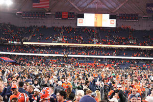 Students and fans storm the JMA Wireless Dome turf after Syracuse defeated No. 8 Miami 42-38. SU’s victory is its first top-10 win since 2017 and its third ranked victory in 2024.