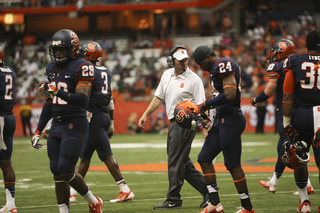 Syracuse head coach Scott Shafer instructs cornerback Jaston George.