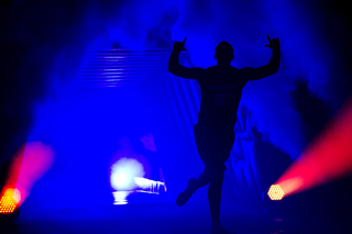 Russ DeRemer jogs out of the tunnel and through the fog during player introductions.