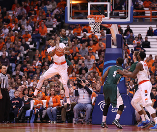 McCullough pulls down a rebound with Barnard on his back.