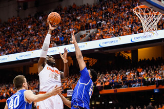 Christmas lofts a hook shot against Okafor. The SU senior had only three points in the opening frame.