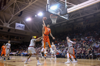 Gbinije soars for a one-handed dunk in the second half while a BC defender tries to block him from behind.