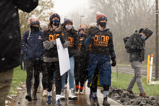 To show their support for Black athletes, administrators, coaches and students, the women's cross country team marches together through the snow.